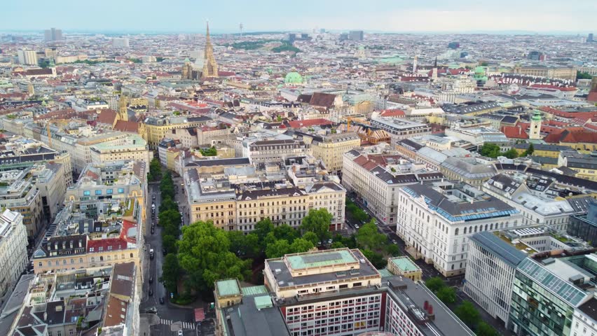 Vienna , Austria - 04 18 2024: Aerial view of Vienna, Austria, showcasing a dense urban landscape with historic buildings, streets, and rooftops.