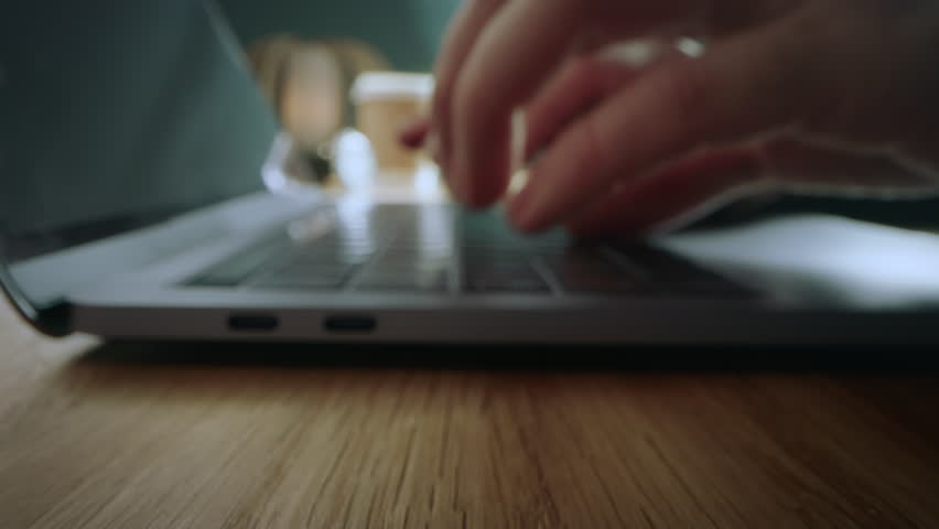 Close Up of a Person Using a Laptop Computer. Hands Type on Keyboard. VFX Digital Icons Showing Different Apps and Software: Online Communication, Business Analytics, Cloud and Others Online Services