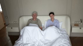 Mature husband and wife argue in bed, tired offended woman turns away in anger during argument. Family couple misunderstanding, ignoring each other, indifference and betrayal in long relationship - Powered by Shutterstock - Get 15% off with code: PIKWIZARD15
