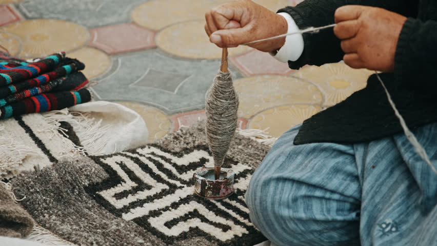 Close-Up Elderly Woman Hand-Spinning Wool onto Bobbin 