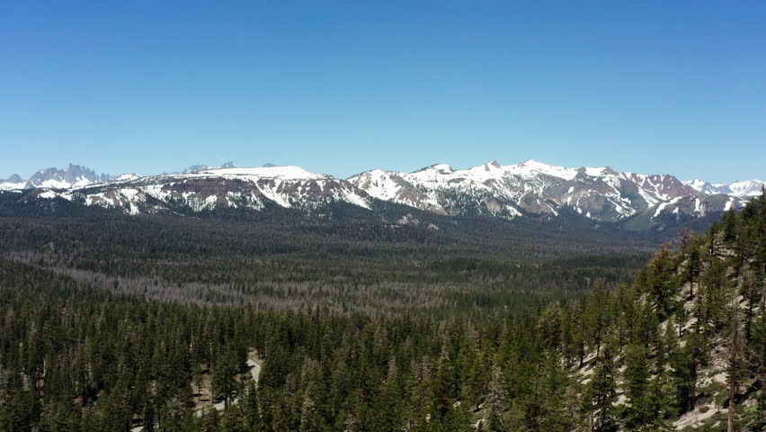 Snow-capped Sierra Nevada mountains under clear blue sky in California, USA
