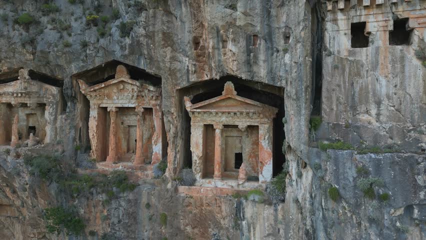 Panorama of Lycian tombs on rocky cliffs near Dalyan, Turkiye. Ancient heritage from Turkey's past. Stone facades in rock faces. Culture and nature unite in southwest Turkiye.