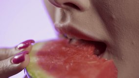 woman eating watermelon in close-up, girly nail polish and red lipstick lips on blue background - Powered by Shutterstock - Get 15% off with code: PIKWIZARD15