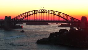 Golden hour sunset Sydney Harbour Bridge Circular Quay wharf ferry boats Australia aerial drone Kurraba Point Mattawunga scenic helicopter flight orange yellow sun reflection static shot - Powered by Shutterstock - Get 15% off with code: PIKWIZARD15