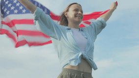 Patriotic woman embracing united states flag, feeling wind and expressing national pride with joy, symbolizing freedom and democratic spirit during outdoor summer moment.Usa celebrate 4th of july. - Powered by Shutterstock - Get 15% off with code: PIKWIZARD15