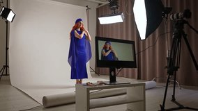 Daily lifestyle concept. Young adult woman spending time at studio, woman model in fancy outfit taking part in a photoshoot in professional studio with photographer and assistants. - Powered by Shutterstock - Get 15% off with code: PIKWIZARD15