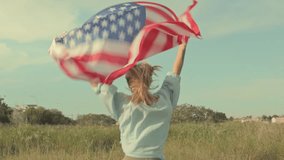 Jubilant woman waving american flag, spinning through grassy meadow under blue sky, embodying patriotic spirit and freedom celebration.Usa celebrate 4th of july. Independence day concept - Powered by Shutterstock - Get 15% off with code: PIKWIZARD15