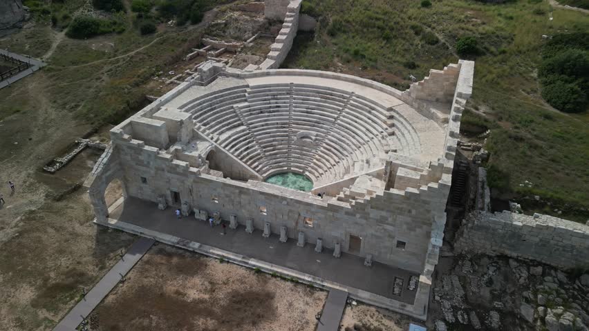 Drone view of Patara's half-round theater in Turkiye. Located in ancient Lycia, this historic site offers a glimpse into Roman architecture. Discover Turkey's rich cultural heritage.