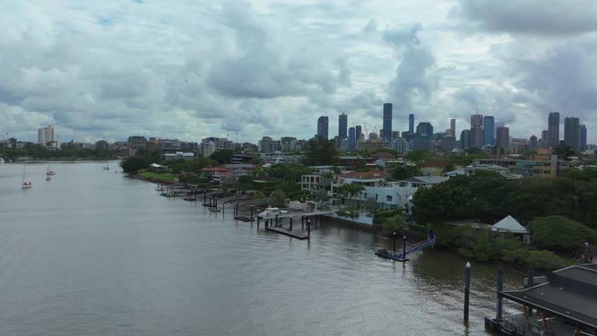Brisbane City River Quay docks sailboats Australia aerial drone BrissySouth Bank Park Skyline skyscraper cranes morning sun rainy clouds Aussie summer autumn winter upward motion