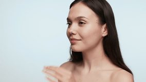Back view of a young female adult adjusting hair and preparing for going out in a beauty concept a plain background. - Powered by Shutterstock - Get 15% off with code: PIKWIZARD15