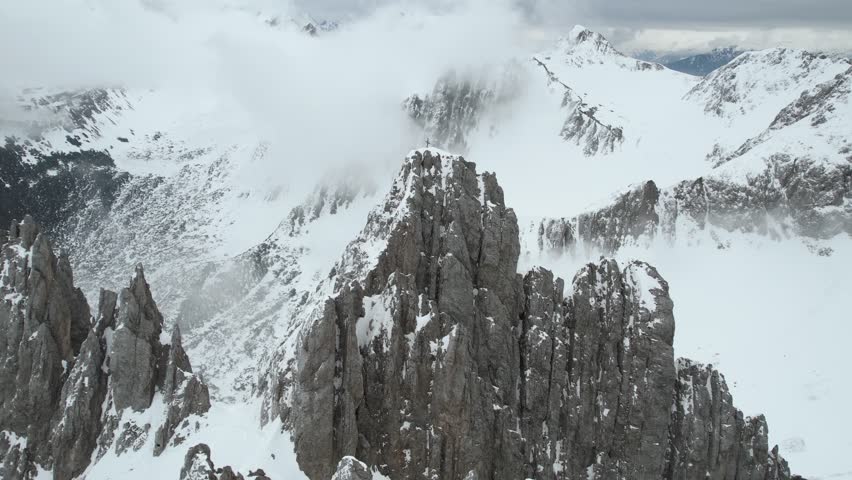 Aerial View of Nordkette Peaks of Austrian Alps Above Innsbruck Ski Resort in Winter Season, Drone Shot