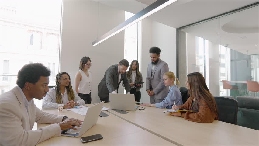 Highly skilled and experienced business diverse team is convening a meeting to thoroughly analyze financial data, systematically review sales reports, and thoughtfully assess current market trends 