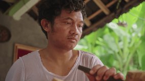 Local Indonesian man working the wood with hammer and chisel - Powered by Shutterstock - Get 15% off with code: PIKWIZARD15