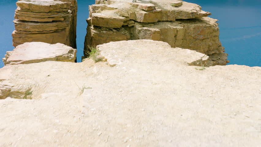 Revealed Afghan Man Over Cliffs Of Band-e Amir National Park In Bamyan, Afghanistan. Aerial Tilt-up Shot