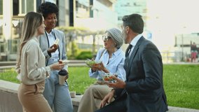 Business professionals sharing healthy lunch, conversing and connecting during midday break in urban park setting, displaying workplace camaraderie and lifestyle - Powered by Shutterstock - Get 15% off with code: PIKWIZARD15