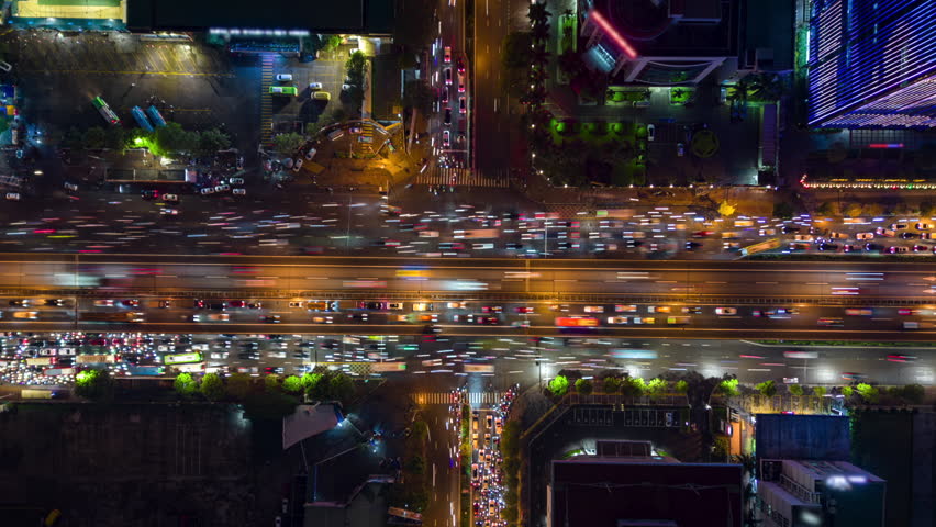 Aerial timelapse of busy city traffic at major intersection at night in Hanoi, Vietnam