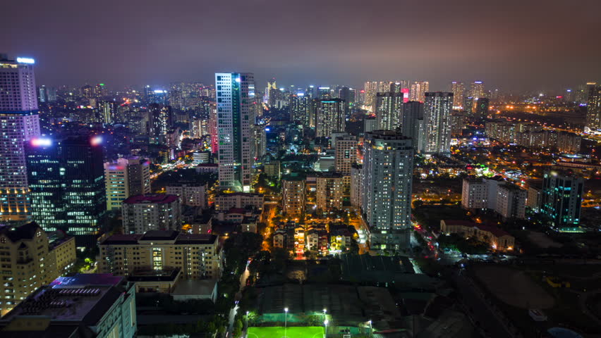 Night timelapse of Hanoi city skyline with illuminated high-rise buildings and traffic lights, Vietnam