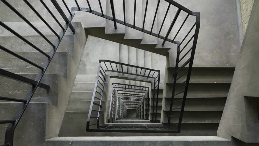 Walking down tower block concrete stairs.
Wide angle shot looking down 10 flights of concrete stairs.
