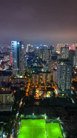 Night timelapse of Hanoi city skyline with illuminated high-rise buildings and traffic lights, Vietnam.