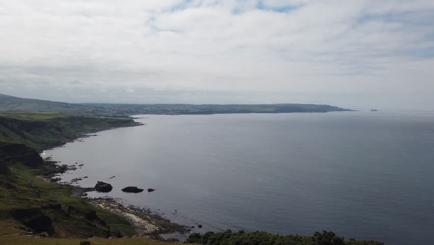 Rugged Northern Irish Coastline and Seaside Town in Background