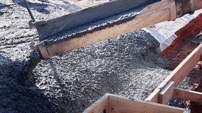 Workers pour fresh concrete foundation slab into wooden forms at construction site - Powered by Shutterstock - Get 15% off with code: PIKWIZARD15