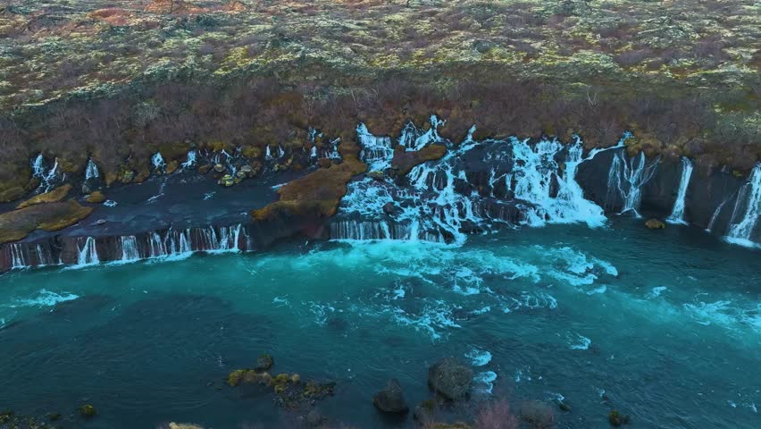 Aerial drone footage of the underground rivers that flow and turn into waterfalls that join the main river.