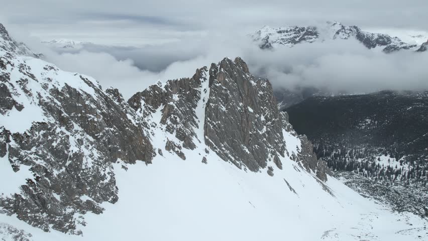 Aerial View of Snow Capped Ridgeline in Austrian Alps Above Innsbruck Ski Resort, Drone Shot