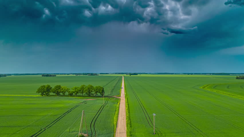 Hyperlapse Of Dark Clouds Moving Over Green Countryside Fields 