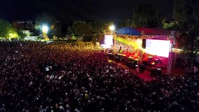 Concert stage and people having fun - Crowd view of people having fun at a concert, stage and spotlights - Powered by Shutterstock - Get 15% off with code: PIKWIZARD15