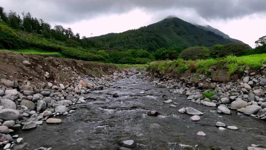 Drone Racing Upstream Through A Riverbed Flowing With Freshwater From The Mountains.