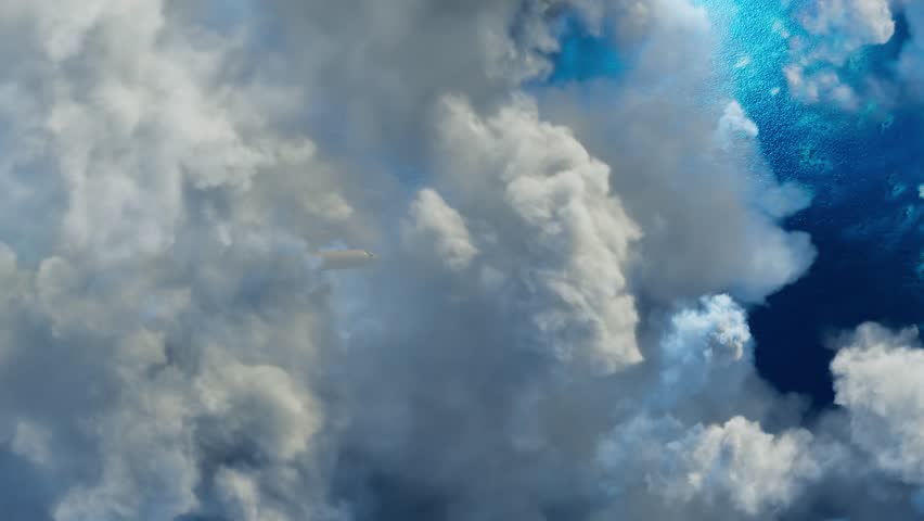 Airplane flies over the blue sea to a beautiful azure coral shore among white clouds. Concept of travel and holidays.