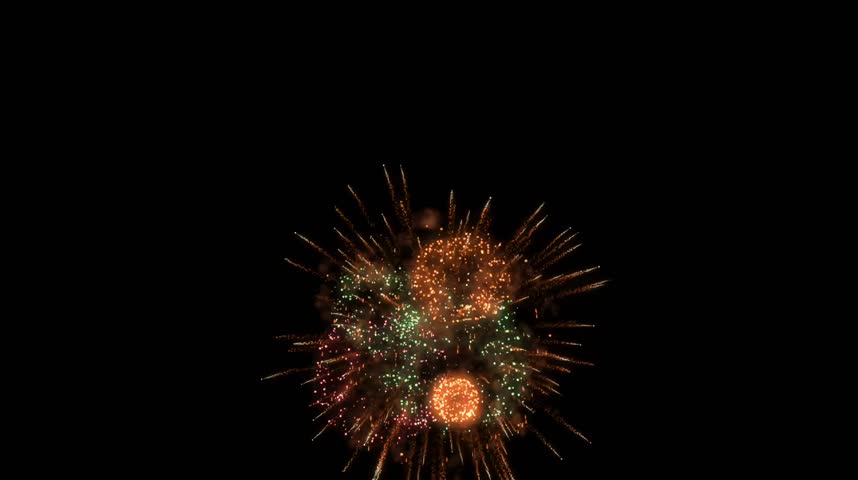 Golden orange fireworks explosion bursting in dark night sky
