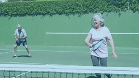 Senior couple playing tennis for fitness, with animated hexagon shapes and GOOD VIBES floating. Athletic, leisure, outdoor, vibrant, health, active, nature - Powered by Shutterstock - Get 15% off with code: PIKWIZARD15