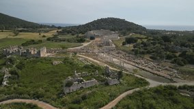 Patara's ancient ruins stretch to the sea in Turkiye. Drone view shows colonnades, arches and theatres. Turkiye's heritage shines in Lycian coastal archaeology. - Powered by Shutterstock - Get 15% off with code: PIKWIZARD15