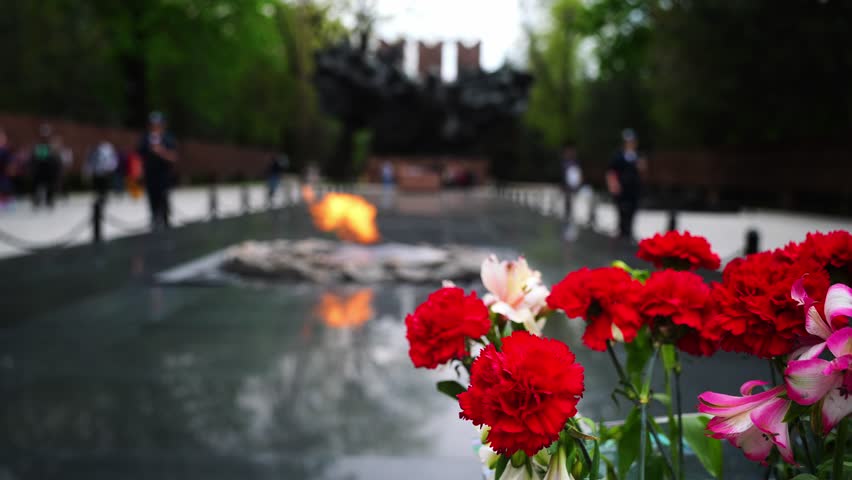 Flowers on the background of eternal flame. Memorial Day, May 9th.