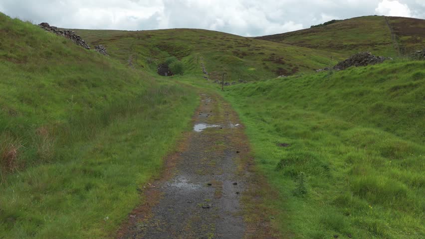 Aerial view of an empty wet roadway in Peak District National Park of Derbyshire, England.