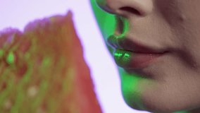 woman eating watermelon in close-up, girly nail polish and red lipstick lips on pink background - Powered by Shutterstock - Get 15% off with code: PIKWIZARD15