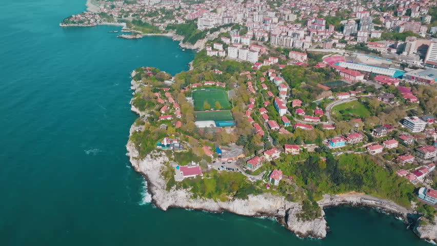 Drone footage circling an astroturf pitch near Fener Limanı, Zonguldak, showing both the pitch itself and the surrounding settlements and the impressive coastline of the Black Sea.