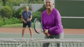 Senior couple playing tennis outdoors for sports data, showing animated pink geometric graphics. Athletic, leisure, vibrant, active, fitness, outdoor, health - Powered by Shutterstock - Get 15% off with code: PIKWIZARD15