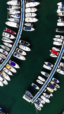 Aerial panoramic drone point of view of boats and yachts moored along docks or piers of marina in Dehesa de Campoamor, Costa Blanca, Province of Alicante. Spain
