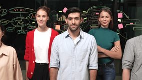 Group of businesspeople applause to celebrate successful project while looking at camera. Professional diverse business team standing at glass wall with marketing strategy, idea,plan. Tracery - Powered by Shutterstock - Get 15% off with code: PIKWIZARD15