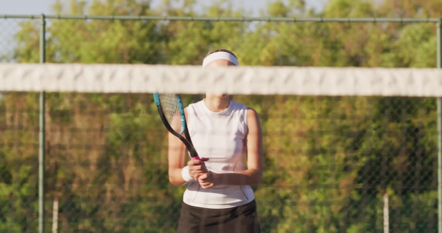 Female tennis player standing on court, holding racket, displaying animated speed gauge for sports. Athlete, sports, leisure, activewear, energetic, outdoor, fitness