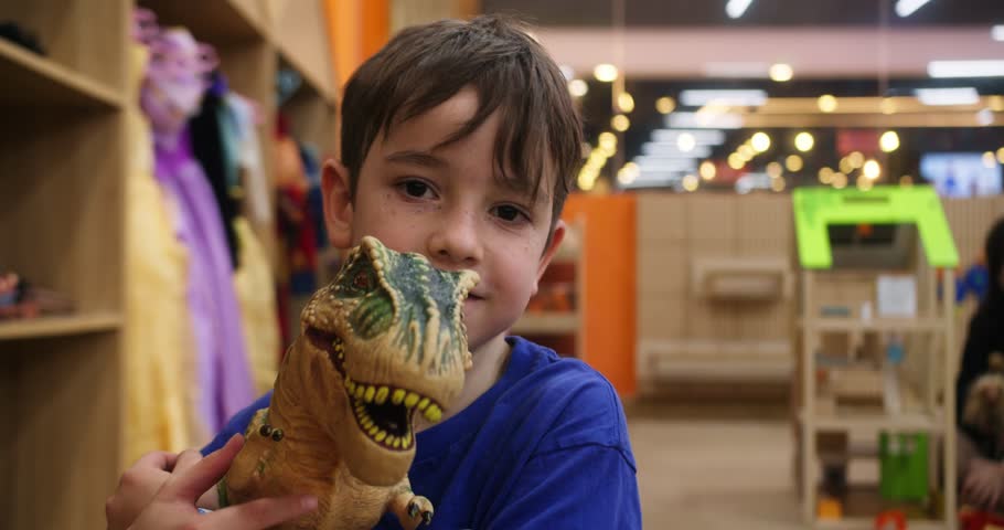 Cute child holds a rubber dinosaur. Vietnam, Hanoi, March 10, 2025. Children play in the children