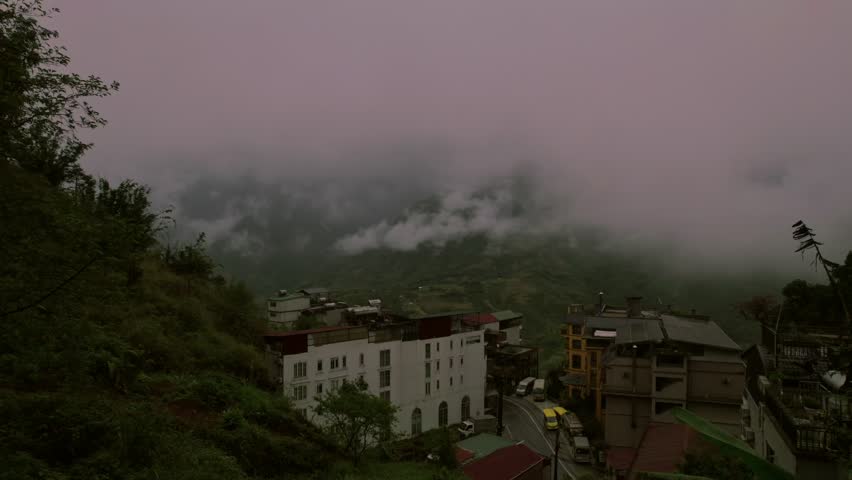 Misty mountain town to terraced rice fields in Sapa, Vietnam - aerial