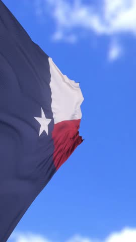 Texas State Flag Waving Proudly Against Bright Blue Sky