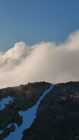 Clouds Roll Over Snow-Capped Mountain Peak in British Columbia, Canada