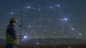 Male technician using tablet in wind farm at dusk, showcasing energy technology network graphics. Renewable, energy, industry, digital, technology, outdoors, infrastructure - Powered by Shutterstock - Get 15% off with code: PIKWIZARD15