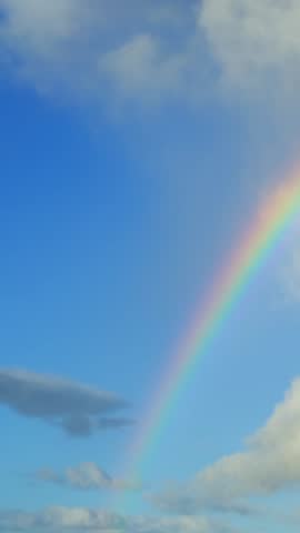 Vanishing rainbow in the sky after rain. Time lapse video of a natural phenomenon when the sunlight. Sunlight splits into different colored rays because of moisture droplets in the air.