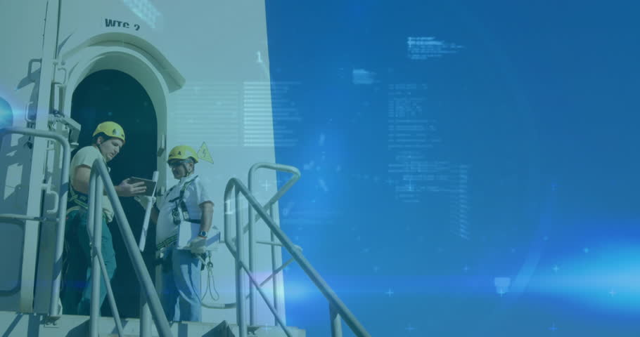 Industrial workers checking handheld device on metal stairs, presenting animated stock graphs. Industrial, technology, safety, communication, progress, automation, engineering