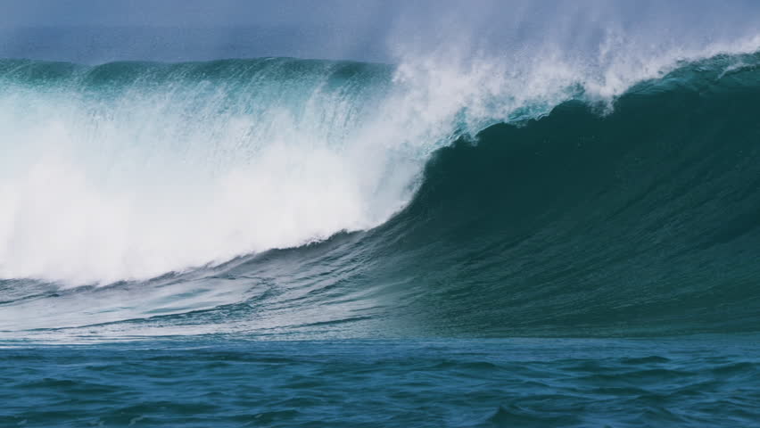 CLOSE UP, SLOW MOTION: Powerful and empty ocean wave crests and breaks under clear blue skies. Perfect shape and offshore spray coming off the lip reflect perfect surf conditions at Canary Islands. - Powered by Shutterstock - Get 15% off with code: PIKWIZARD15